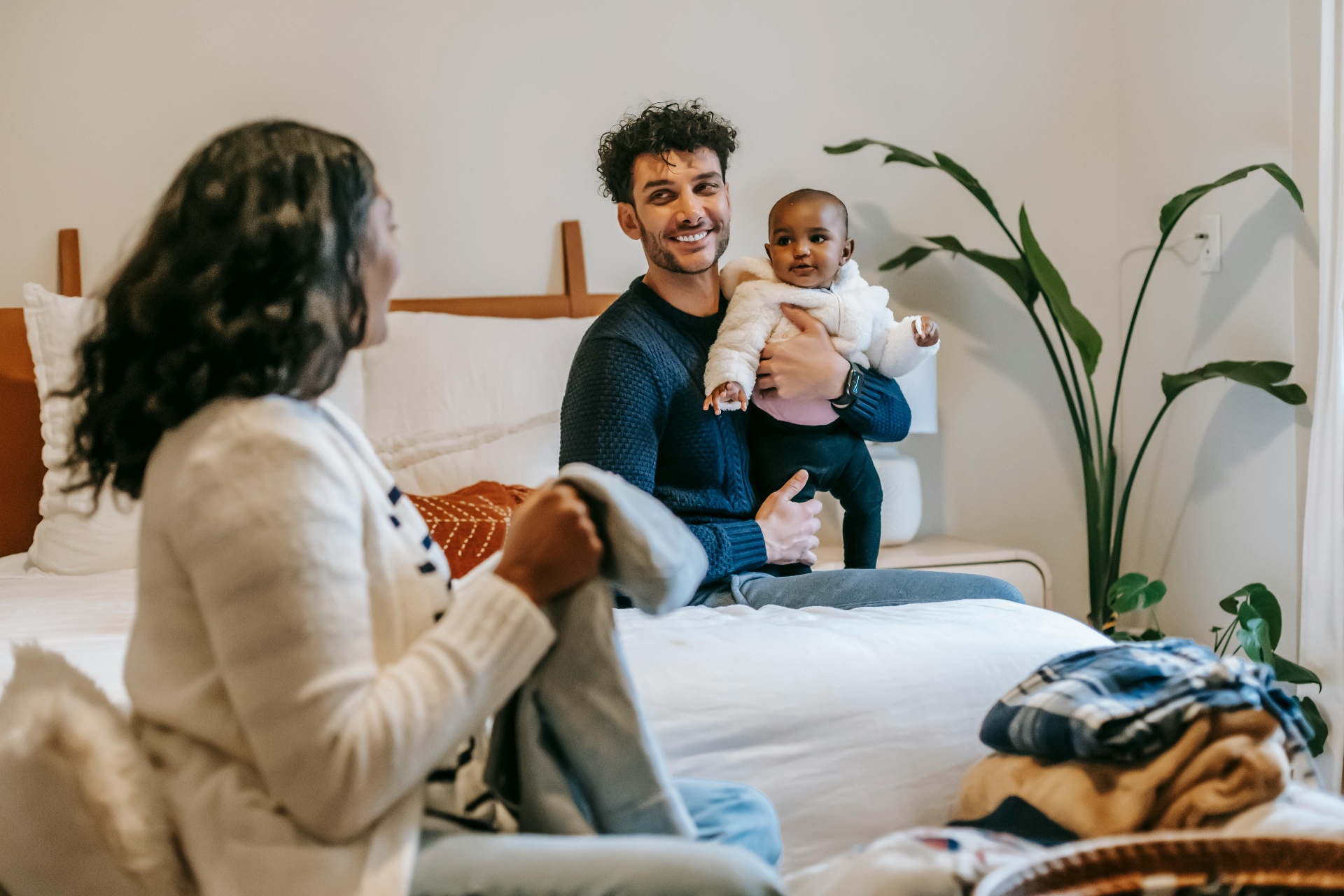 Happy family relaxing together in a bright living room with clean fresh air and houseplants